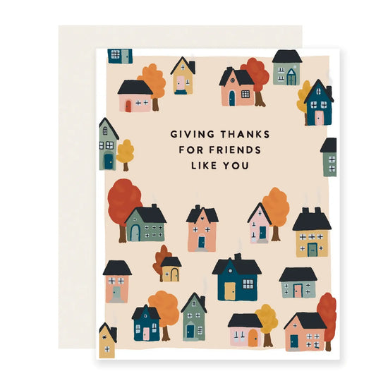 White card with beige background. Colorful illustrations of houses and fall trees. Black text “giving thanks for friends like you”