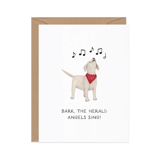 White card with an illustration of a dog barking and music notes. Black text “bark! The herald angels sing!”