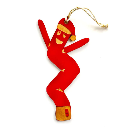 Red air dancer shaped ornament wearing a Santa hat