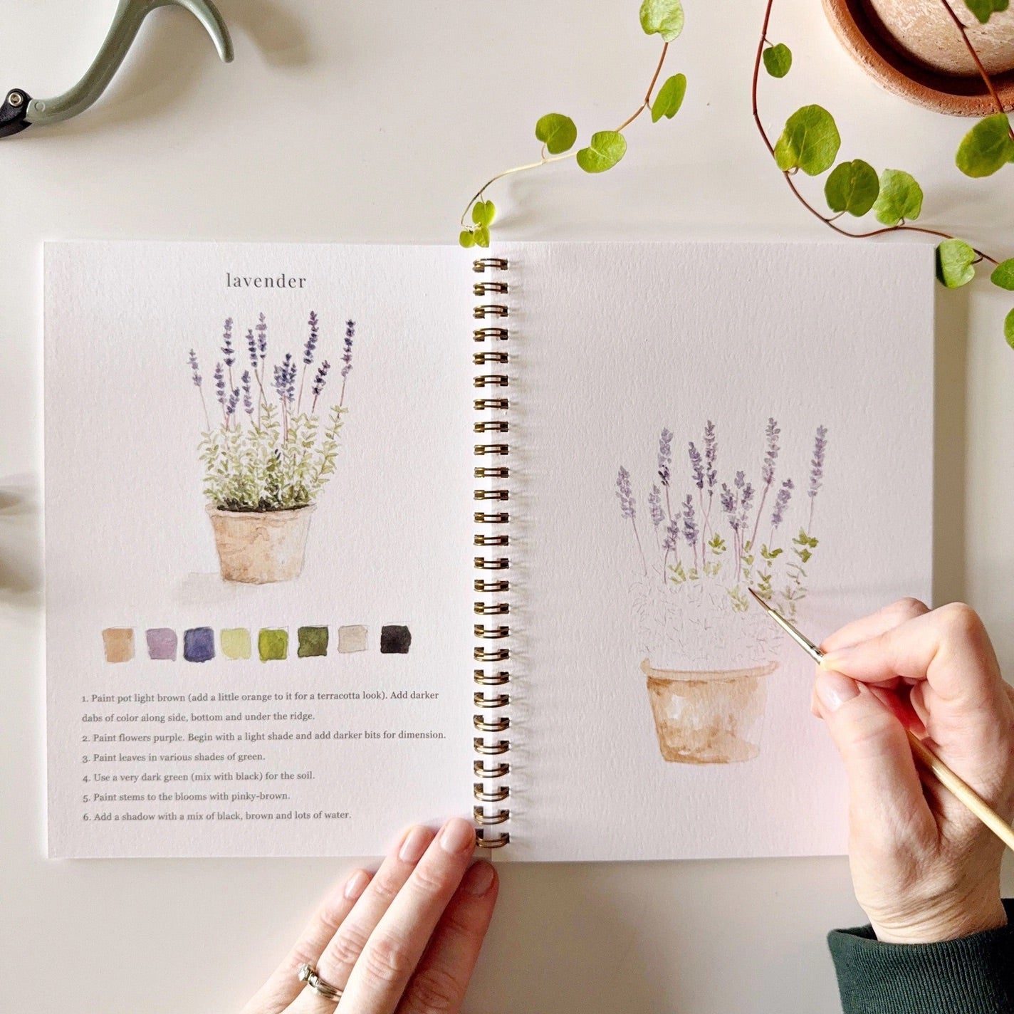 Person painting lavender watercolor page 