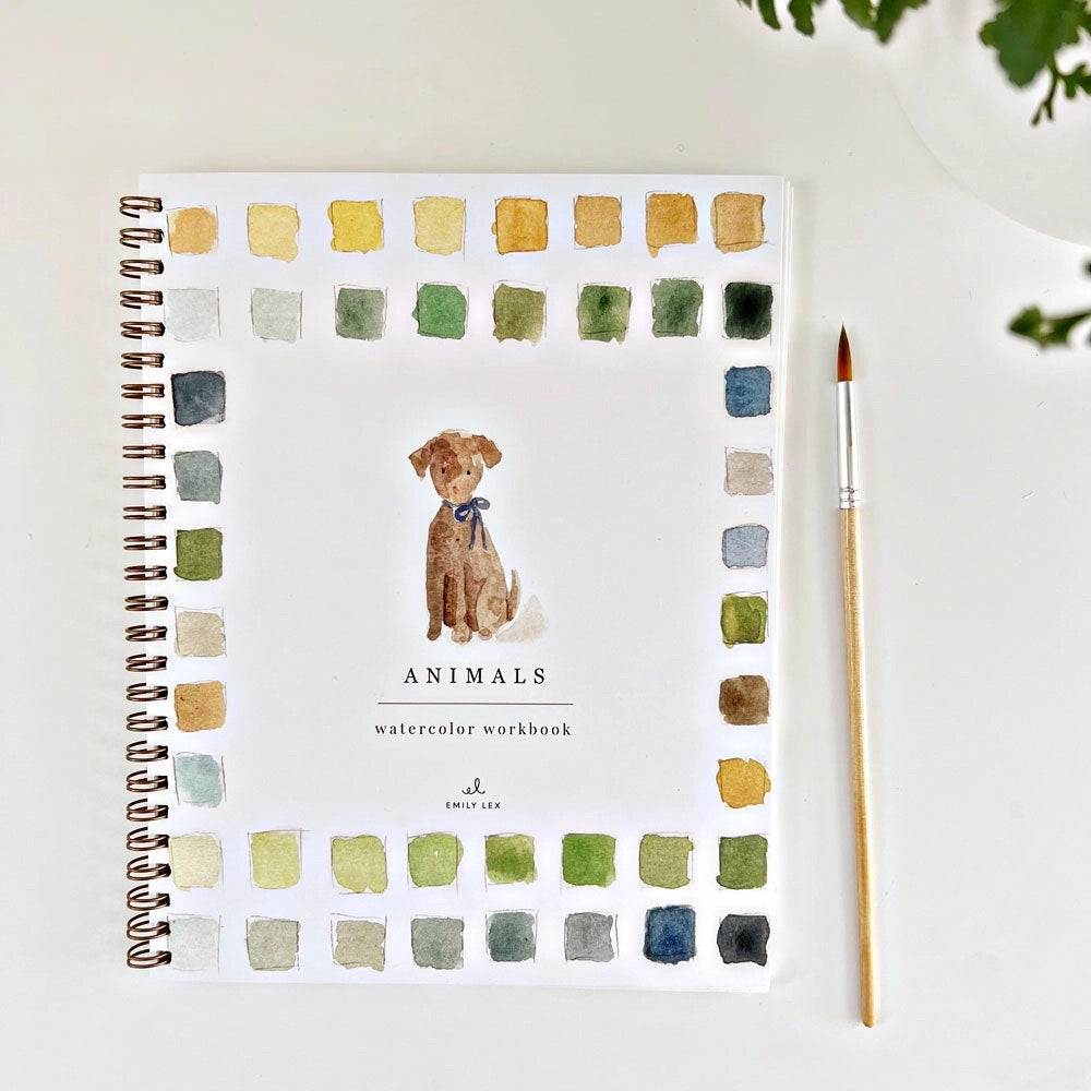 Spiral-bound watercolor workbook with white cover and a dog painting. Black text reads "animals watercolor workbook." 