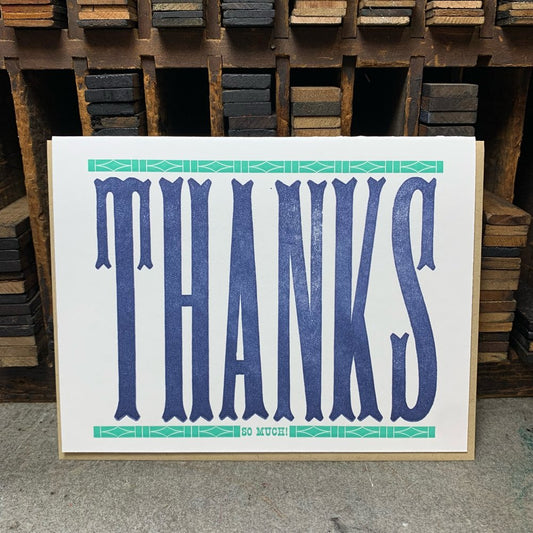 White card with "thanks" letterpress printed in navy ink. Green bar above and below text. 