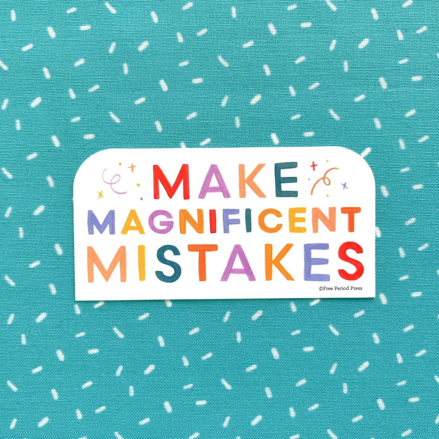 Rectangle shaped sticker. Rainbow text on a white background. Text: make magnificent mistakes 