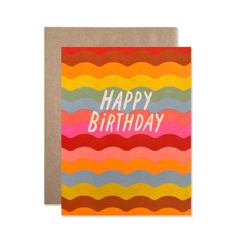 White card with full multicolor wave background. "happy birthday" in white text. 