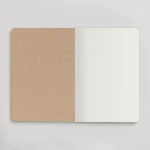 Inside view of notebook. Tan back of front cover and blank white page. 