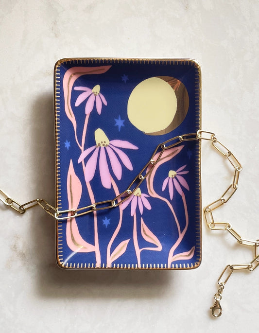 Rectangle dish with full color navy background. Yellow sun and pink flower painted design. 