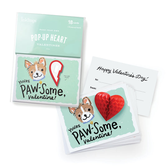 Boxed set of valentines featuring a dog and a red heart. Black text “you’re paw-some valentine”