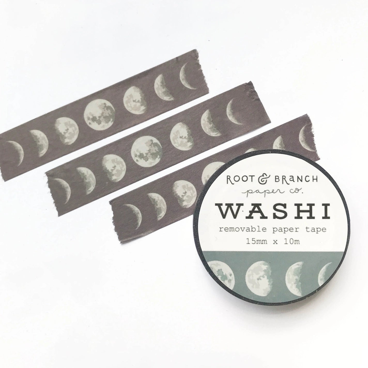 Front view of washi tape and three pieces of tape. Washi is black with white moon phase pattern.