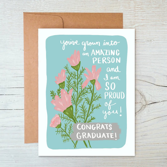 Greeting card with floral design and text on a wooden surface