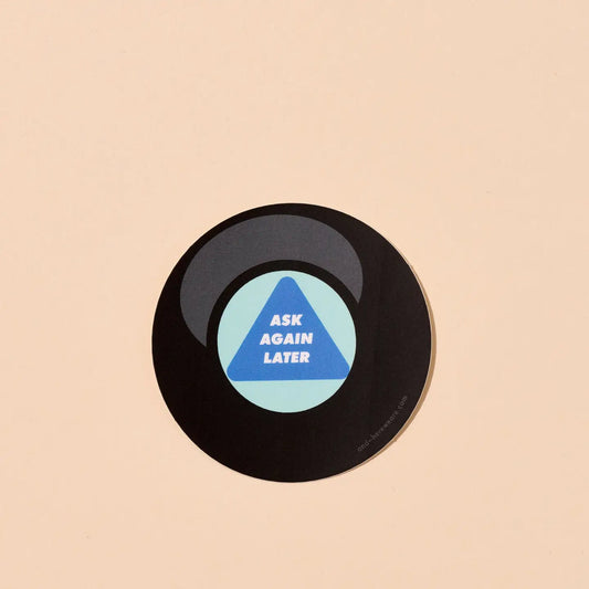 Round sticker of a magic eight ball. Text “ask again later” 
