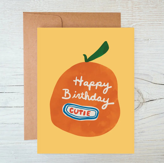 Birthday card with an orange illustration and 'Happy Birthday Cutie' text on a yellow background