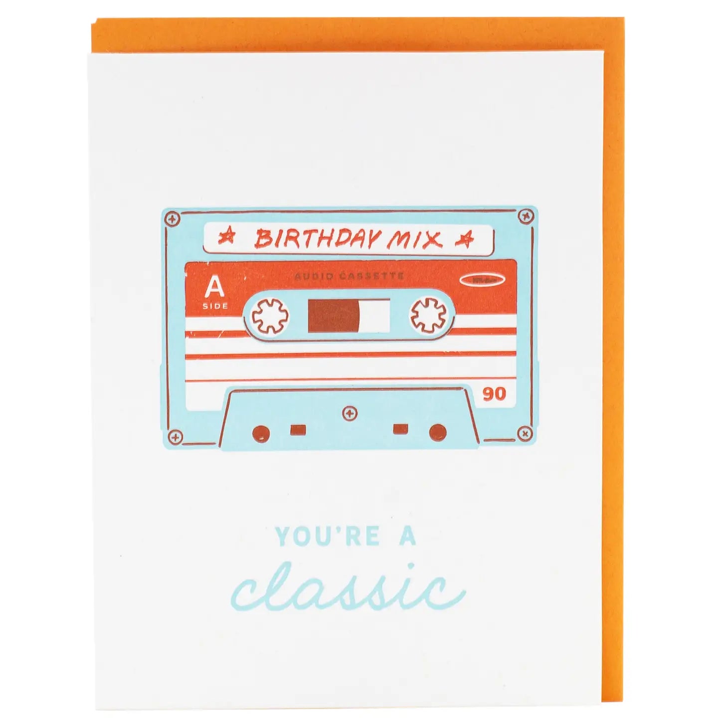 White greeting card with a picture of a cassette tape labeled “birthday mix.” Blue text, you’re a classic 
 