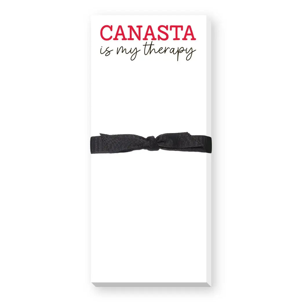 Notebook with a black ribbon on a white background, featuring the text 'CANASTA is my therapy'.