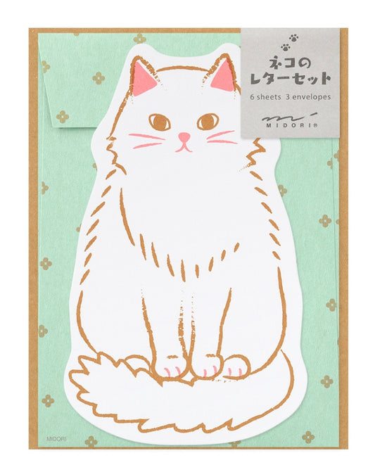 Die-cut cat letter writing sheets in front of mint green envelopes