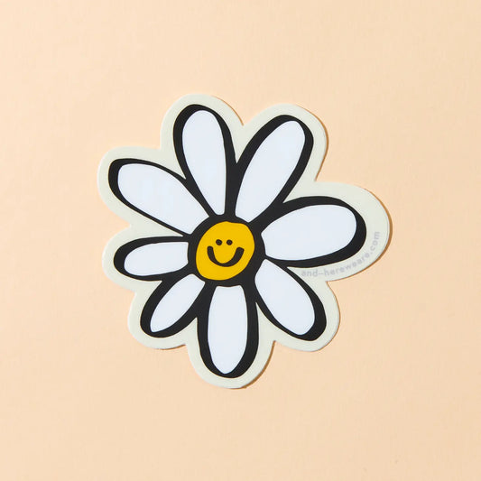 A vinyl sticker of a happy daisy with a smiling face on a light background.