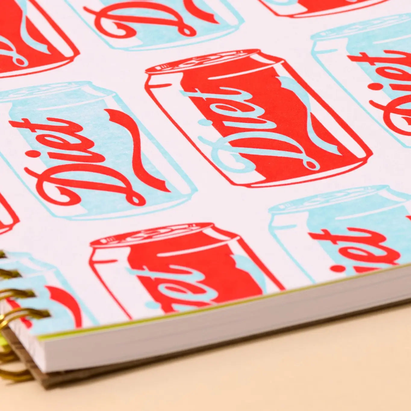 Notebook with red and blue soda can design on the cover