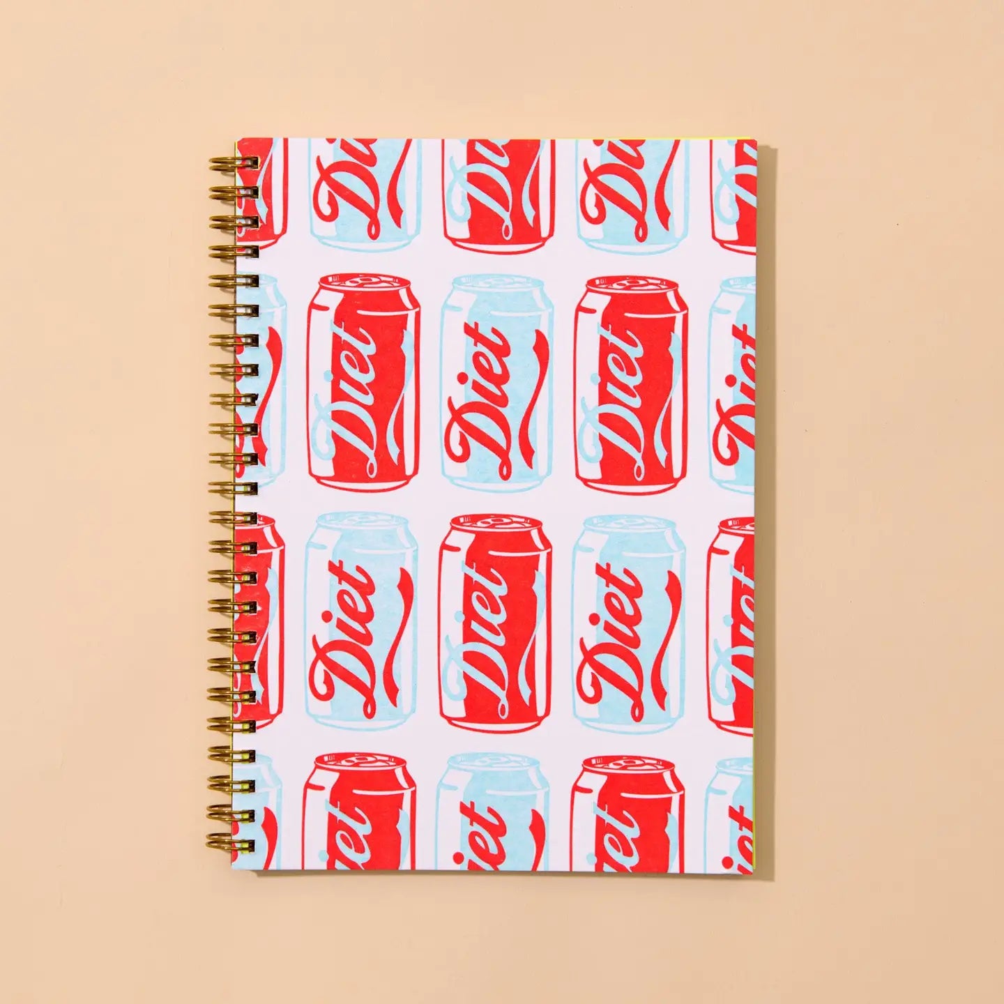 Notebook with diet soda can pattern on a beige background