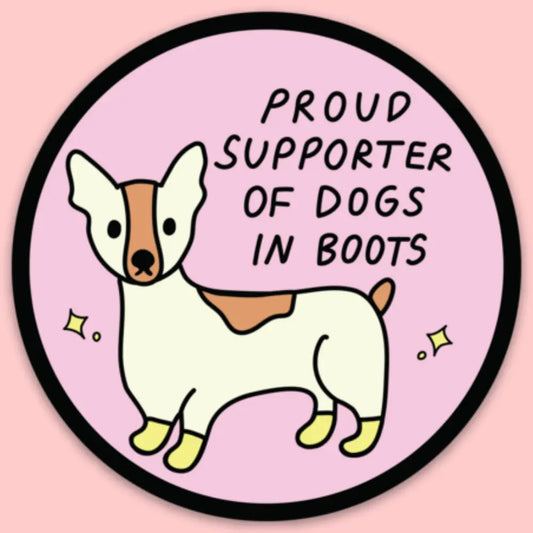 Circular sticker with a cartoon dog and text 'Proud Supporter of Dogs in Boots' on a pink background