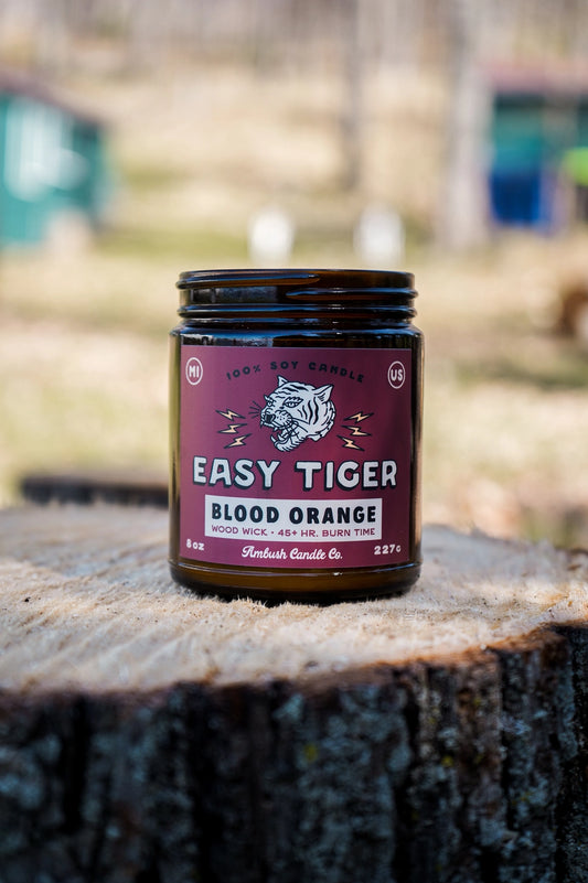 Jar candle with red label featuring a tiger illustration. 