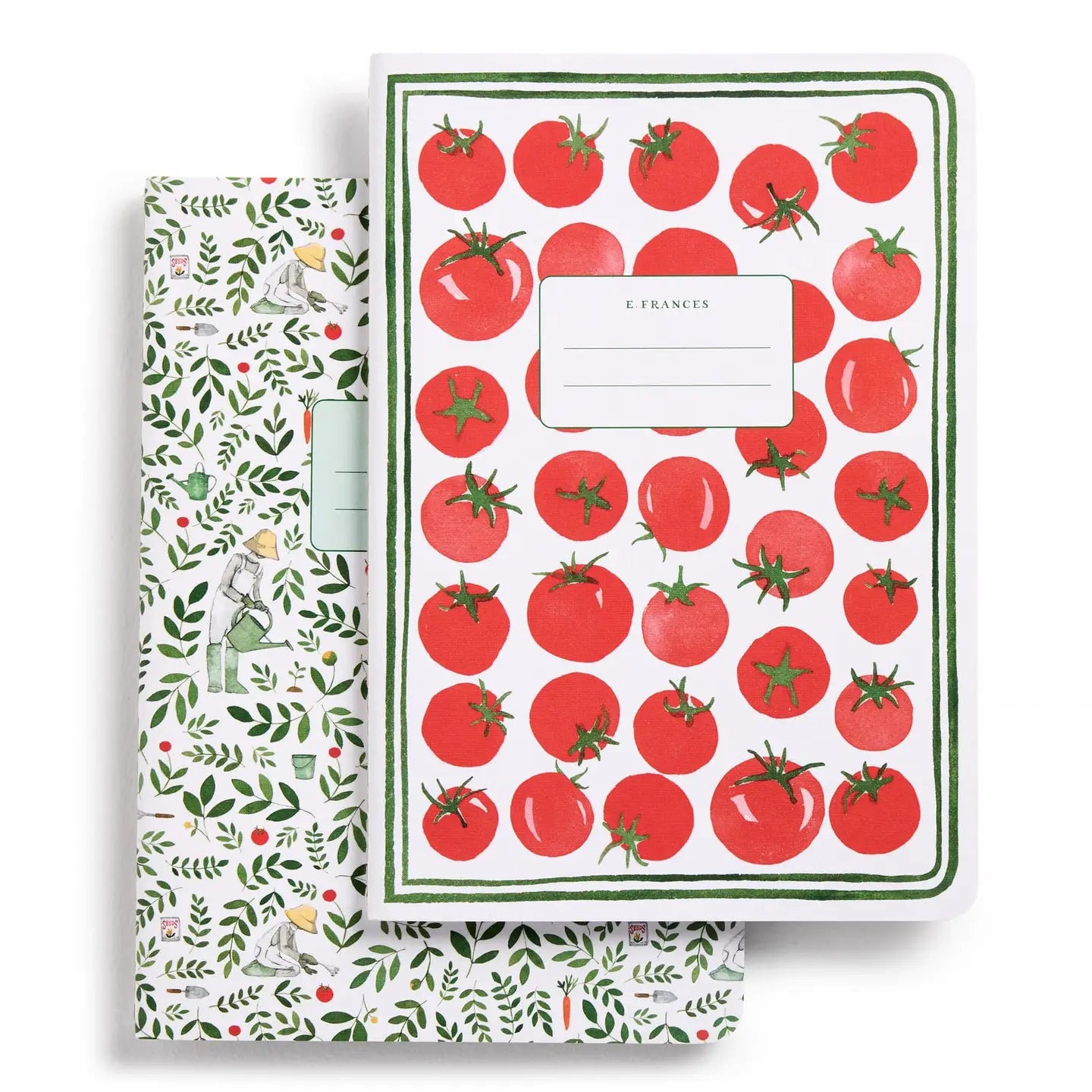 Notebook with tomato pattern and another with garden-themed design on a white background