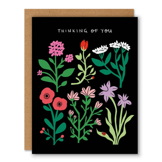 Greeting card with colorful floral design and 'thinking of you' text on a black background