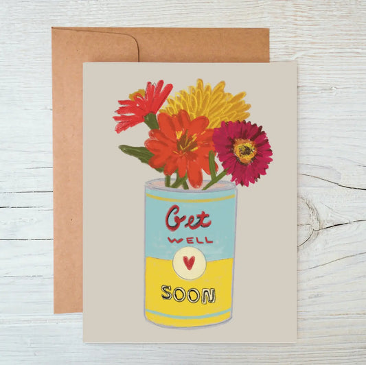 Greeting card with 'Get Well Soon' message and colorful flowers on a wooden surface