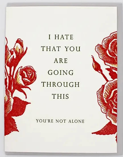 Card with red floral design and supportive message on a white background