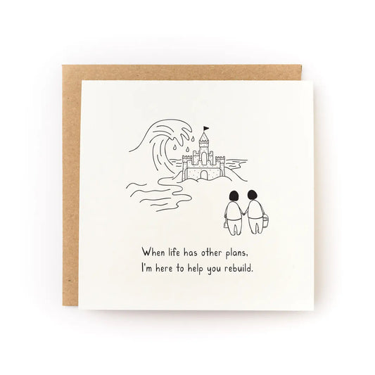 Greeting card with illustration of two people and a sand castle, with text 'When life has other plans. I'm here to help you rebuild.