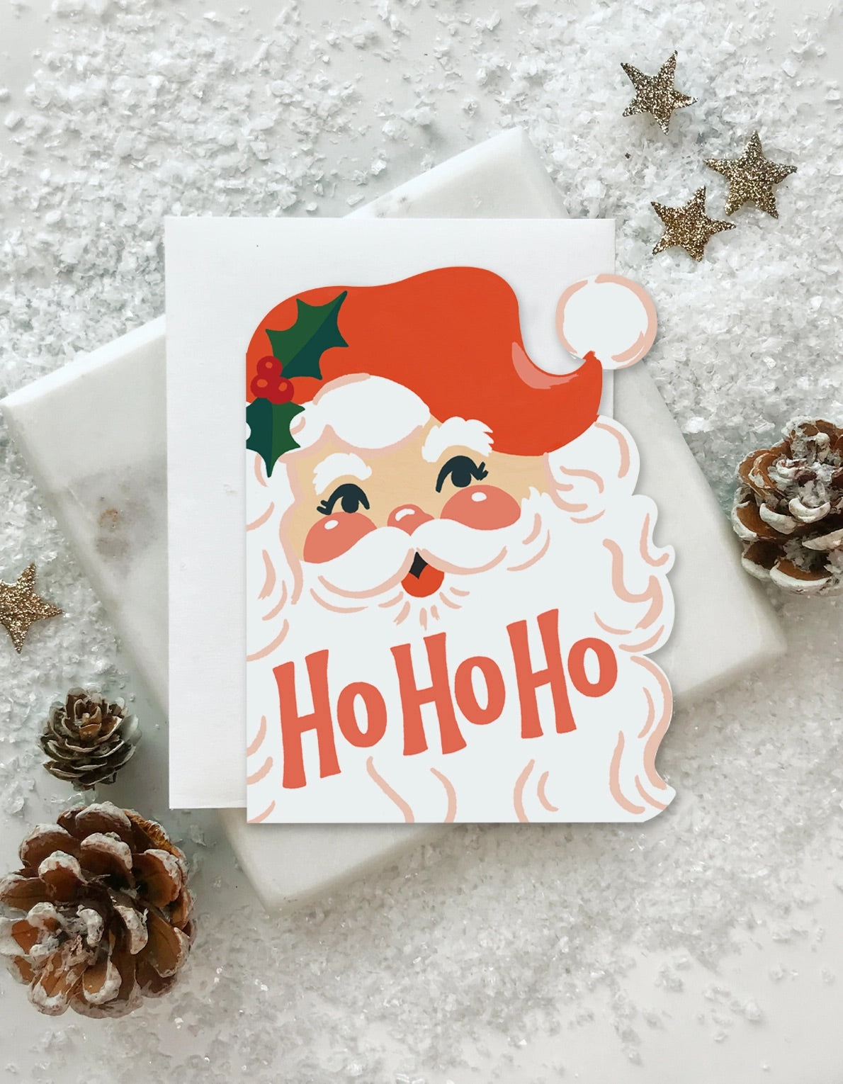 Die-cut greeting card in shape of Santa. Ho ho ho in red text 