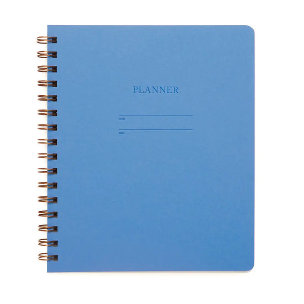 Blue planner cover. "Planner" is letterpress printed into the cover. 