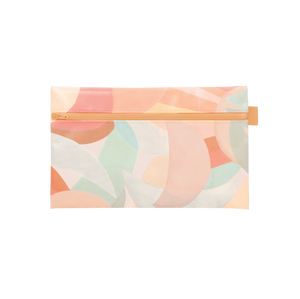 Top view of pencil case with shades of pink, yellow, and teal shapes. 