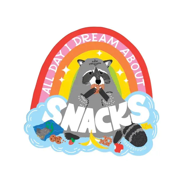 Die-cut sticker featuring a rainbow and a raccoon illustration. White text reads "all day I dream about snacks." 