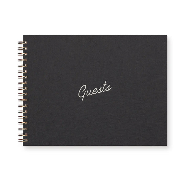 Spiral-bound black notebook with white text reading "guests" 