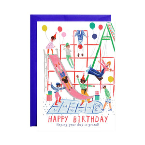 White card with illustrations of kids on a playground. Red text reads "happy birthday." Black text reads "hoping your day is grand!" 