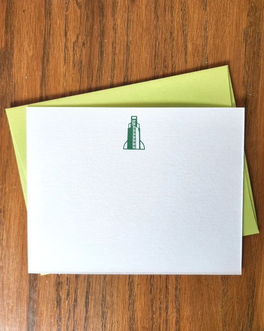White notecard with green bell tower