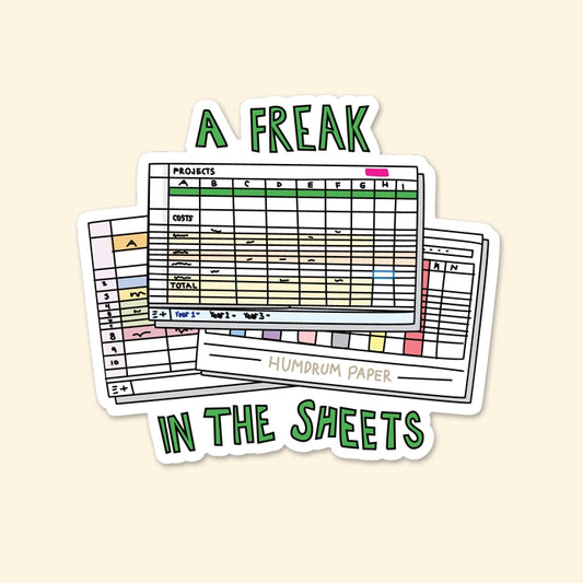 Die-cut sticker of three excel spreadsheets. Green block letters: a freak in the sheets 