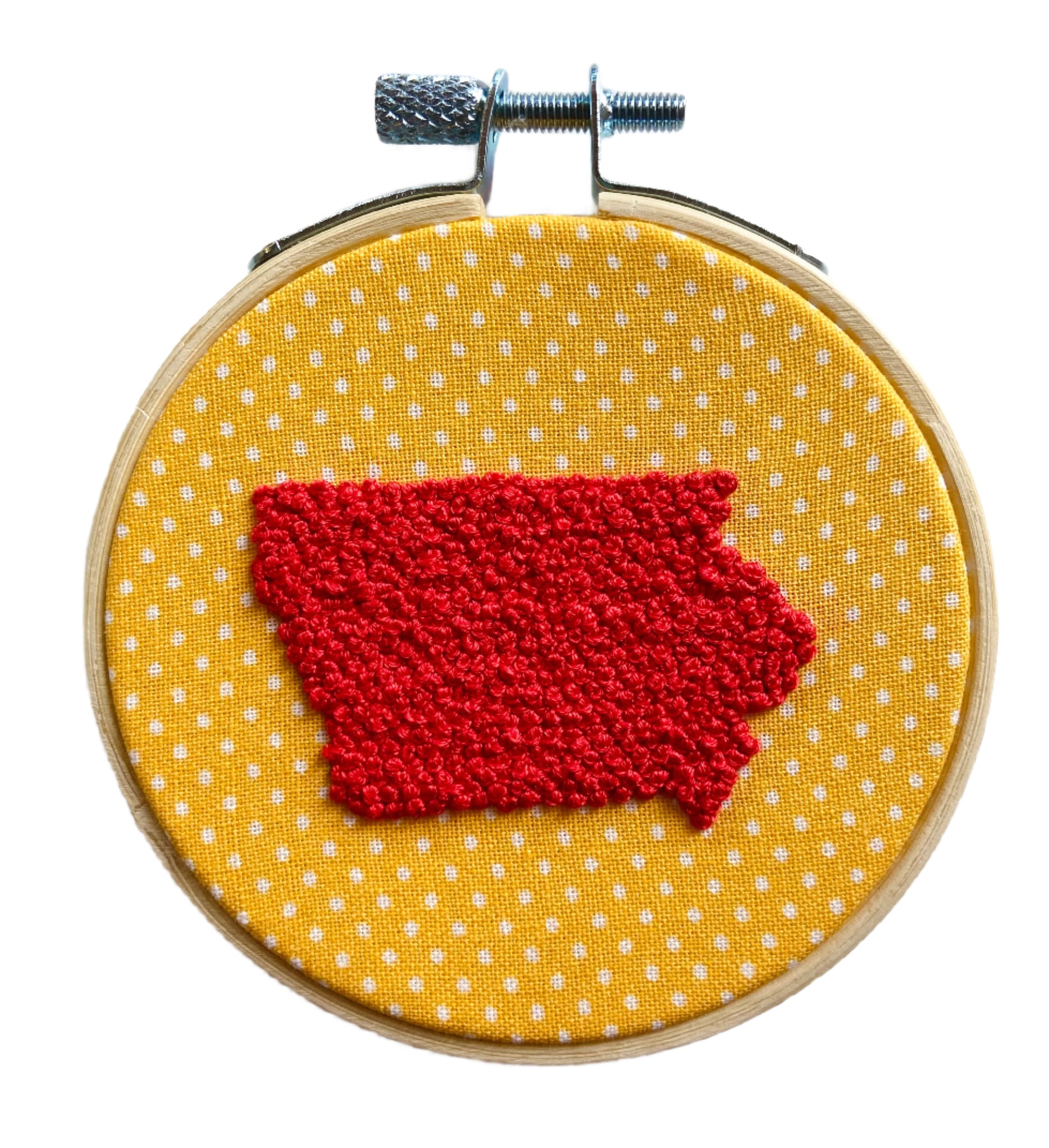 Embroidery in hoop. Yellow and white polka dot fabric with french knots in the shape of Iowa 