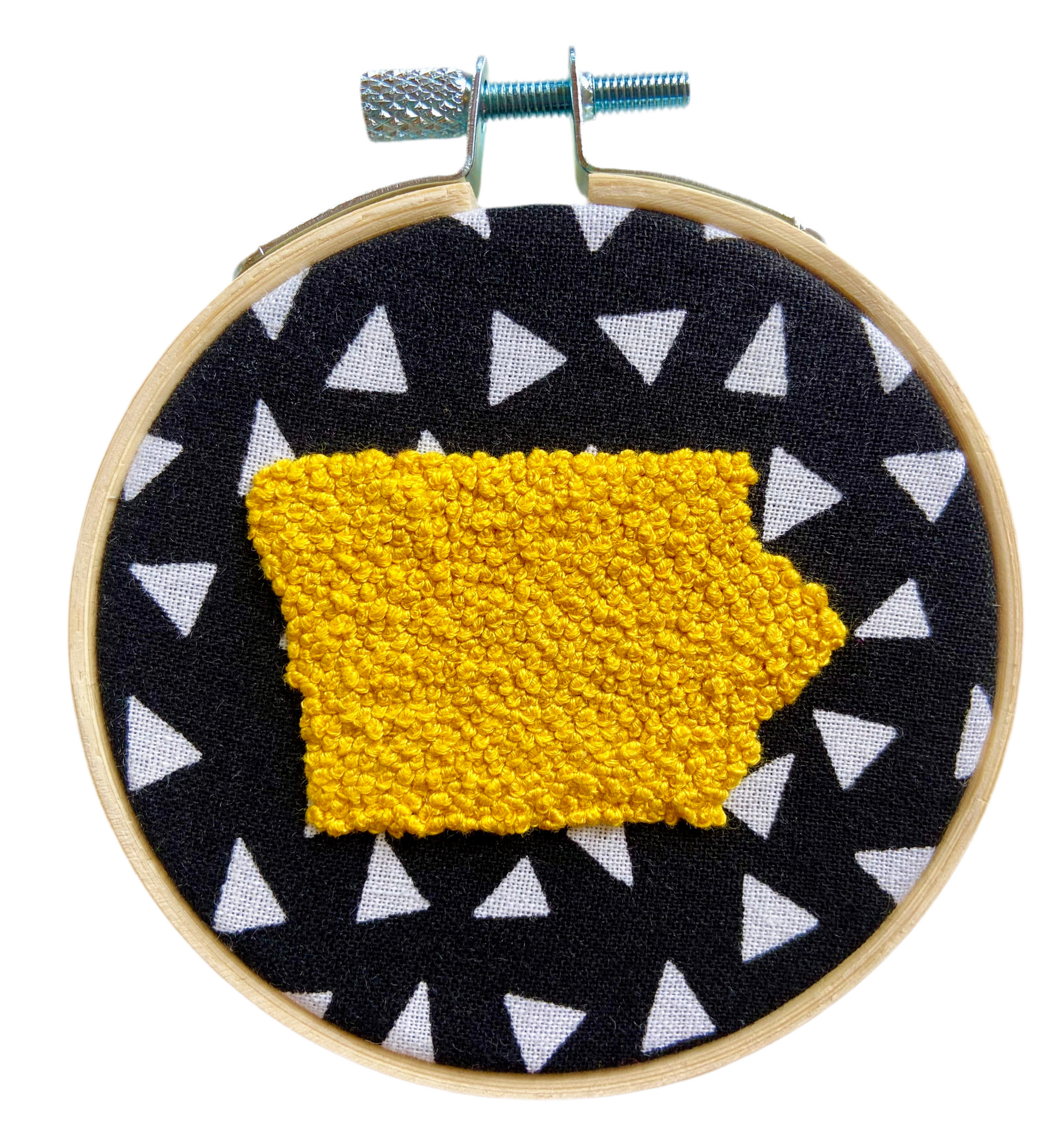 Embroidery in hoop. Black fabric with white triangles. Yellow Iowa 