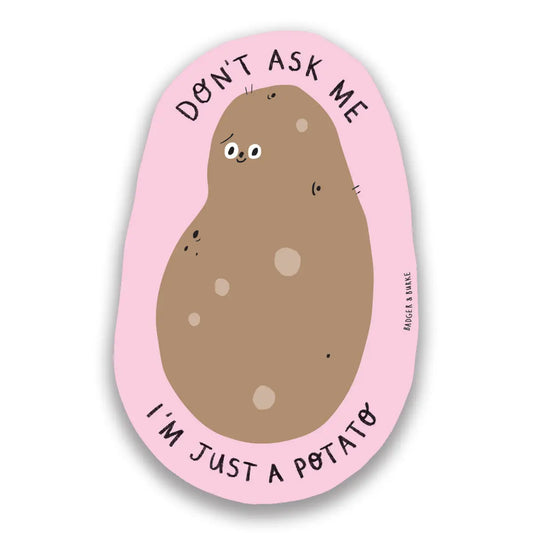 Die-cut sticker in the shape of a potato. Pink border around the potato. Black text: don’t ask me I’m just a potato 