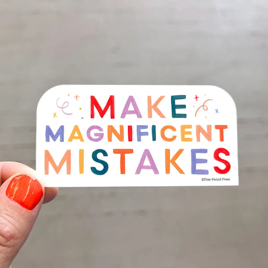 Rectangle shaped sticker. Rainbow text on a white background. Text: make magnificent mistakes 
