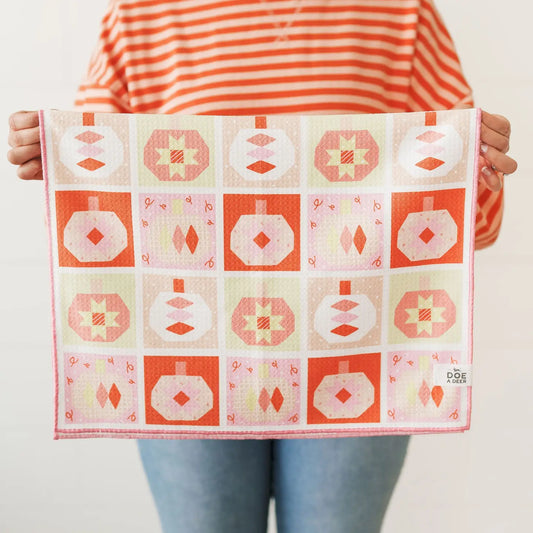 Person holding a pumpkin patterned towel