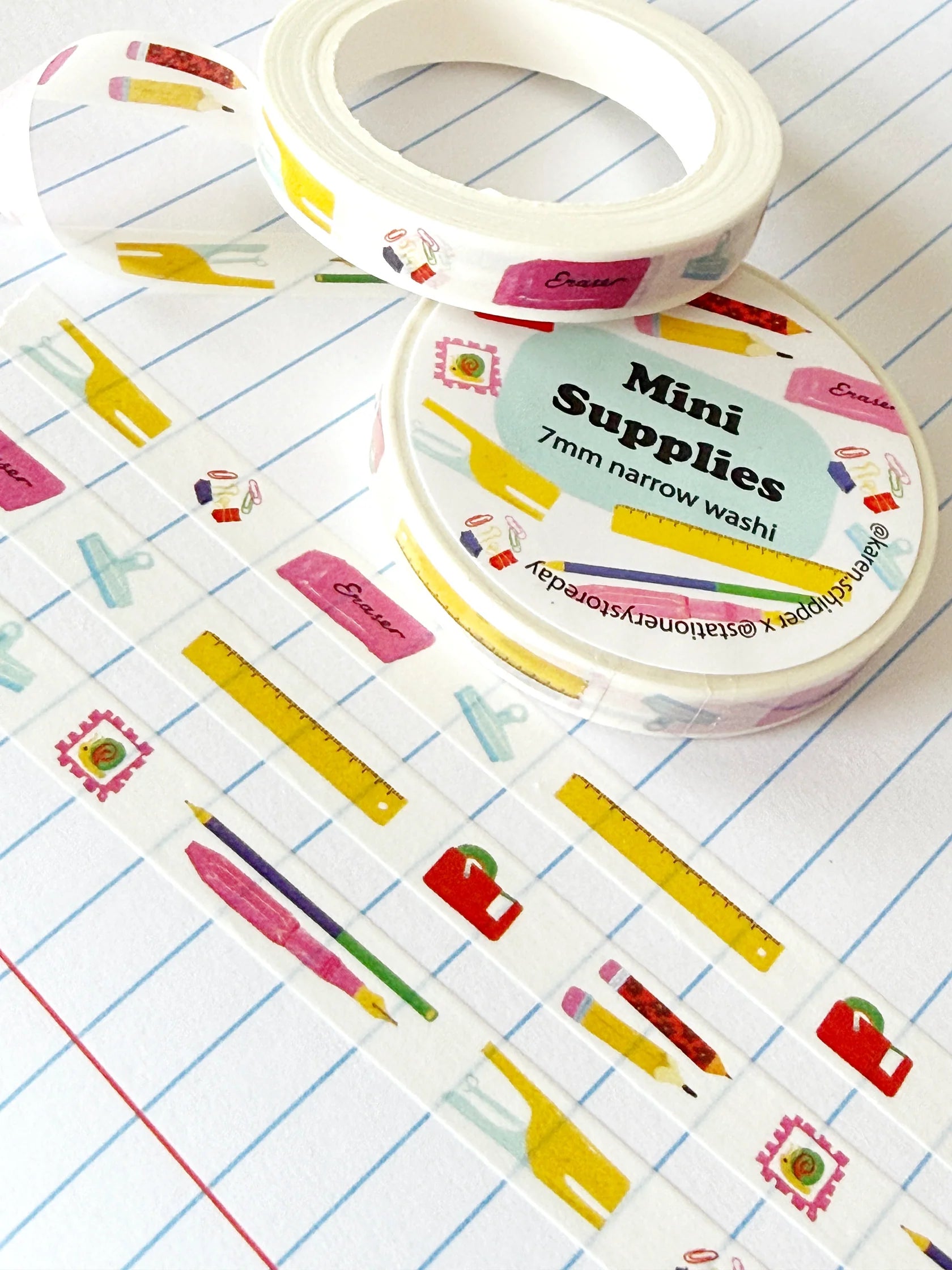 Decorative washi tape with colorful stationery designs on a lined paper background