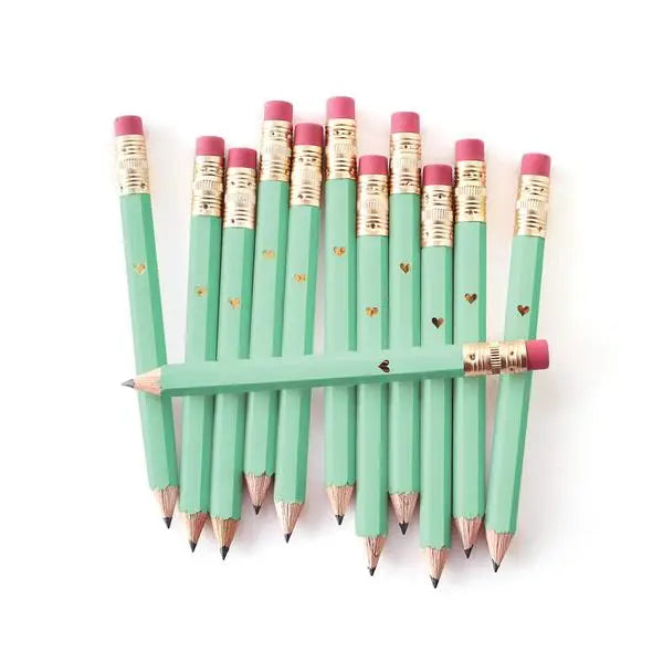 A group of mint green mini pencils with gold heart imprints and pink erasers.