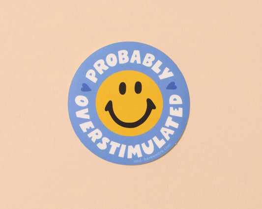 Circular sticker with smiley face and text 'Probably Overstimulated' on a beige background