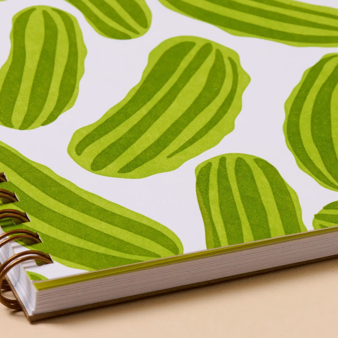 Notebook with green pickle pattern on a white background