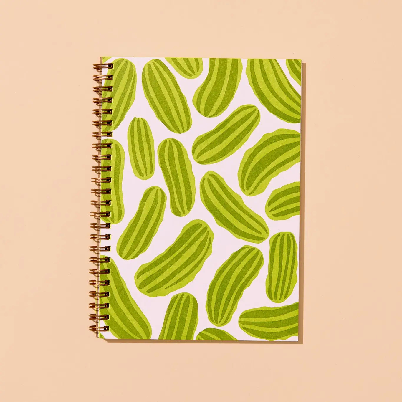 Notebook with green pickle pattern on a beige background