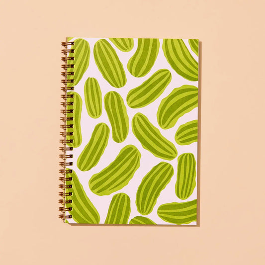 Notebook with green pickle pattern on a beige background