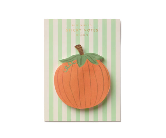 Pumpkin shaped sticky notes on a green background