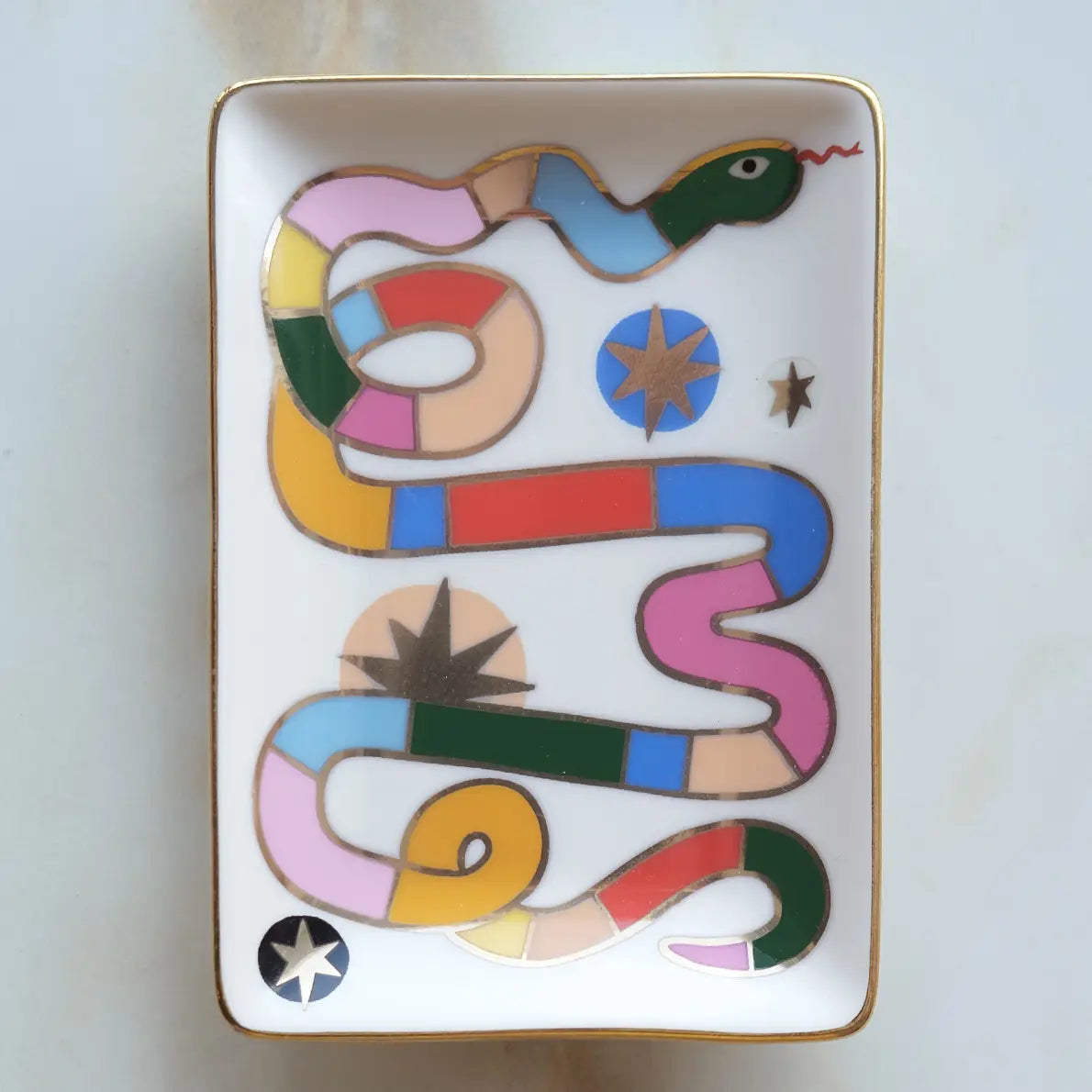 Decorative tray with a colorful snake design on a white background