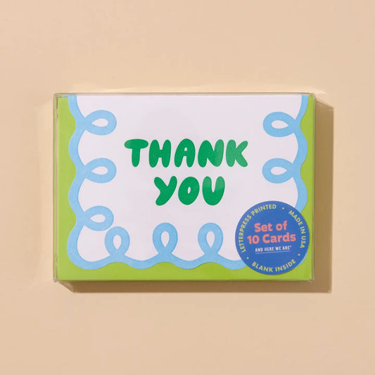 Box of 'Thank You' cards with green text on a beige background